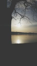 Scenic view of lake against sky at sunset