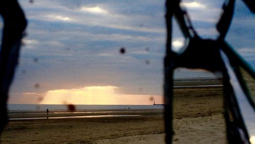 Scenic view of beach against sky during sunset