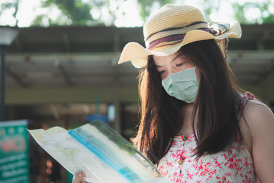 Portrait of beautiful young woman reading book