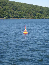 Boat sailing in sea against sky