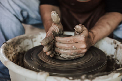 Close-up of artist making pot at workshop