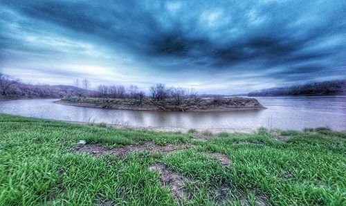 Scenic view of lake against cloudy sky