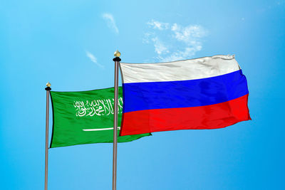 Low angle view of flag against blue sky