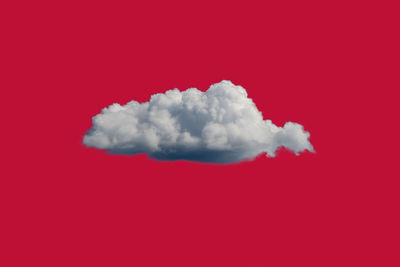 White clouds over red background