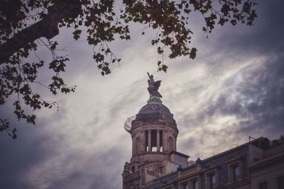 Low angle view of historic building against cloudy sky