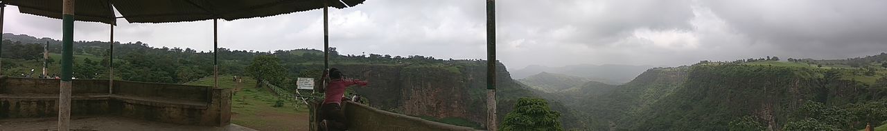 Panoramic view of mountain range against cloudy sky