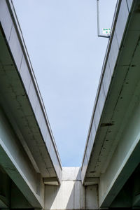 Low angle view of penang bridge against sky in city