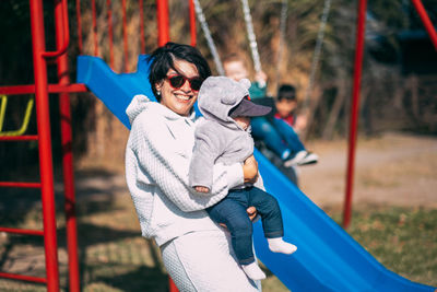 Mom and baby son together in playground