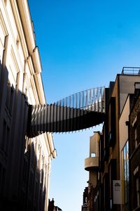 Low angle view of buildings against clear blue sky