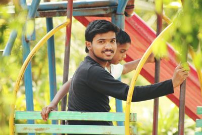 Portrait of young man smiling on landscape