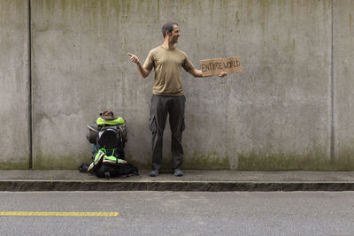 Full length of man standing on wall