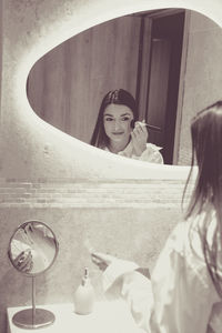 Portrait of young woman sitting on escalator