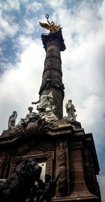 Low angle view of statue against cloudy sky