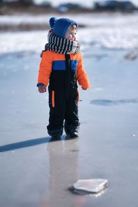 Little boy on ice outdoors in winter