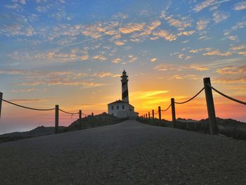 View of lighthouse against cloudy sky during sunset