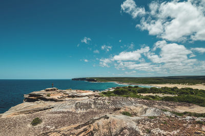 Scenic view of cliff against blue sky