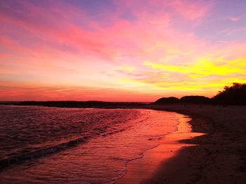 Scenic view of beach against sky during sunset