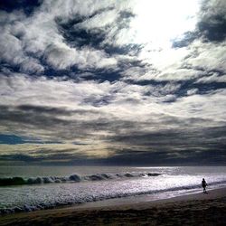 Scenic view of sea against cloudy sky