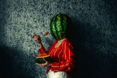 Rear view of girl holding fruit