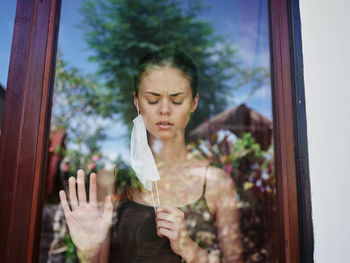 Woman looking through window