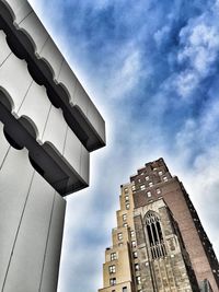 Low angle view of building against cloudy sky