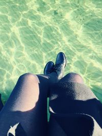 Low section of woman standing in water