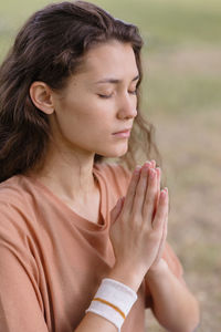 Young woman meditating at park