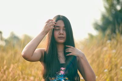 Young woman standing on field