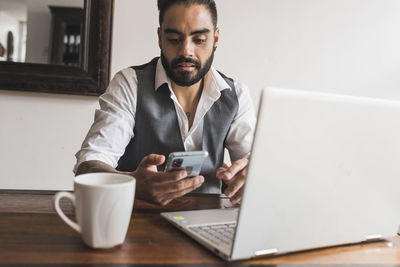 Handsome man dressed as executive chatting on his smartphone