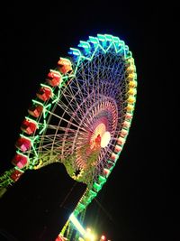 Low angle view of illuminated ferris wheel at night