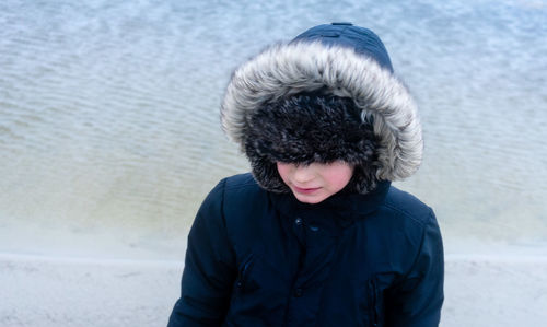 High angle view of woman wearing fur coat at beach during winter