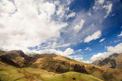 Scenic view of mountains against cloudy sky