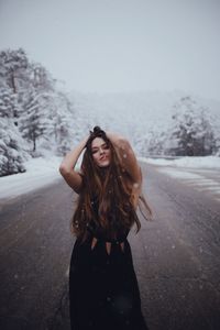 Young woman standing in snow