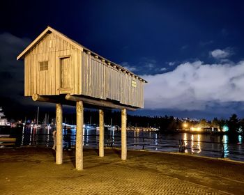 Built structure on beach against sky at night