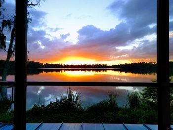 Scenic view of lake against sky during sunset
