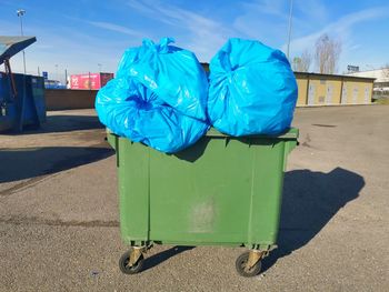 Garbage can on blue table in city