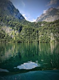 Scenic view of lake and mountains against sky