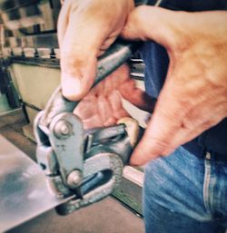 Close-up of cropped hand holding outdoors