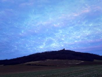 Scenic view of landscape against cloudy sky