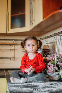 Portrait of girl sitting at home