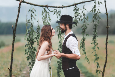 Young couple kissing against blurred background