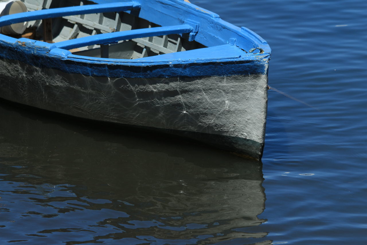 water, nautical vessel, boat, transportation, mode of transport, moored, rippled, blue, waterfront, lake, reflection, rope, day, part of, outdoors, nature, river, no people, cropped, close-up