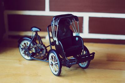 Close-up of toy pedicab on table at home