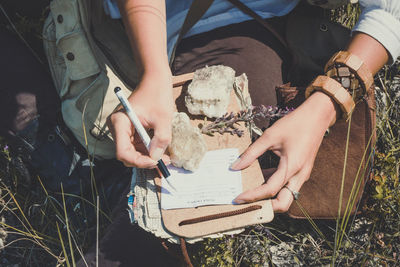 Close up woman writing notes during hike concept photo