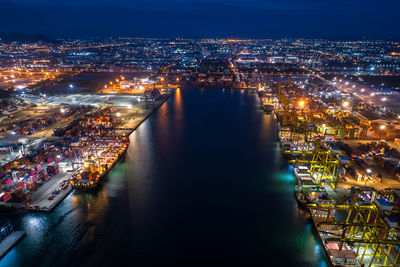 High angle view of city lit up at night