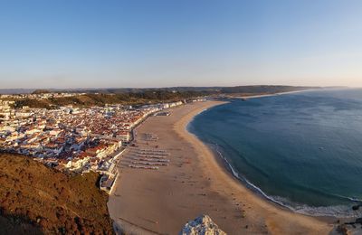 High angle view of sea and buildings against sky