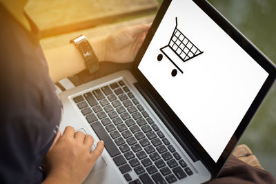 Cropped image of man doing online shopping