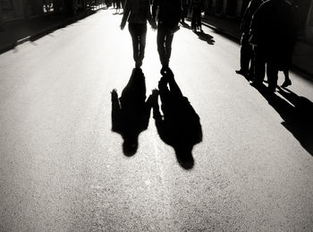 Low section of people walking in city