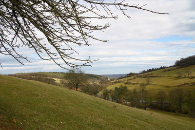 Scenic view of landscape against cloudy sky