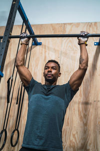 Low angle view of man exercising in gym